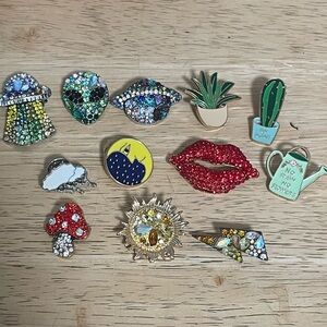 12 various pins; garden, sun, moon, lightening, cloud, lips, mushroom, aliens